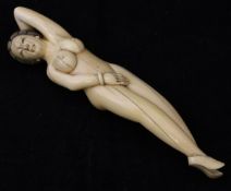 A Japanese Meiji Period carved ivory medical figure as a reclining nude,