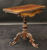 A Victorian mahogany card table, the fold-over top with serpentine front and reeded edge,
