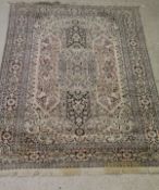 An Eastern cream ground rug with central medallion overlaying three oblong medallions with