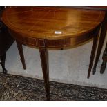 Two 20th Century mahogany demi-lune side tables in the Georgian style