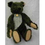 A Steiff Harrods musical bear, limited edition green plush, with button in ear,