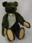 A Steiff Harrods musical bear, limited edition green plush, with button in ear,