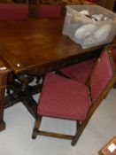 An oak refectory style dining table in the 17th Century manner on cup and cover supports,
