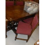 An oak refectory style dining table in the 17th Century manner on cup and cover supports,