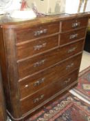 A Victorian mahogany chest of four short over three long drawers with carved ribbon handles,