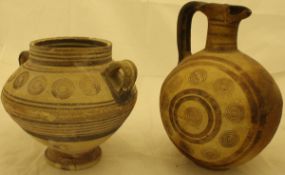 A Cypriot iron age pottery ewer or Oinochoe of globular form with roundel decoration,