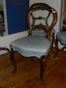 A collection of eight Victorian walnut balloon back dining chairs with matching upholstery (4 plus