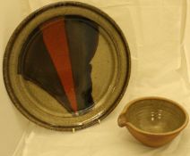 John Leach Studio Pottery plate on a beige ground with brown red and brown striped flash with a