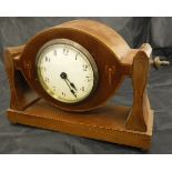 An Edwardian mahogany and inlaid adjustable mantle clock with of propeller centre form with a