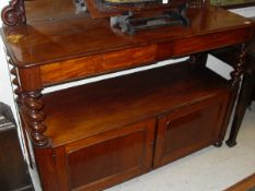 A Victorian mirrored back buffet of two drawers to the top on barley-twist supports to the second
