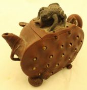 A 20th Century Yi Xing teapot as a cut lotus pod, the body with reticulated seeds,