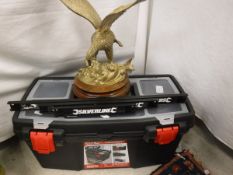A toolbox and tools including a magnetic strip for tools, a brass eagle ornament,