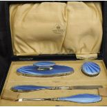 A George V silver and blue guilloche enamel decorated manicure set (by Mappin & Webb Birmingham