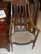 A set of three Edwardian mahogany and inlaid salon elbow chairs with swept arms and shaped seat,