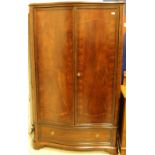 A modern mahogany serpentine fronted wardrobe in the Louis Philippe taste,