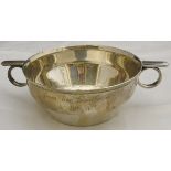 A George V silver porringer of plain form with two lug handles inscribed "Angela Neale 26th January