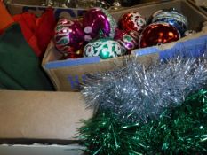 Two boxes containing a small collection of assorted Christmas decorations,