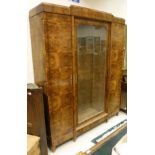 An early 20th Century burr yew bookcase cabinet in the Biedermeier style,