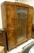 An early 20th Century burr yew bookcase cabinet in the Biedermeier style,