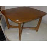 An Ercol elm coffee table, the rounded rectangular top on moulded supports,