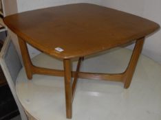 An Ercol elm coffee table, the rounded rectangular top on moulded supports,