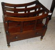 A Victorian mahogany three section Canterbury with single drawer on turned legs to brass caps and