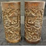 A pair of 19th Century Chinese carved bamboo brush pots decorated with scholars conversing in and