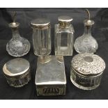 A pair of cut glass oil and vinegar bottles with silver spouts,