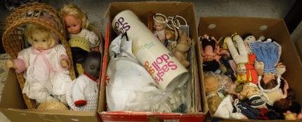Four various dolls and cane crib, a box of various dolls clothing, kid and other gloves,