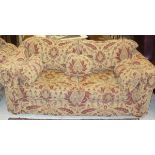 A pair of Multiyork terracotta on gold floral decorated scroll arm sofas and matching stool