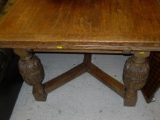 An early to mid 20th Century oak draw-leaf dining table in the Elizabethan Revival taste,