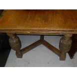 An early to mid 20th Century oak draw-leaf dining table in the Elizabethan Revival taste,