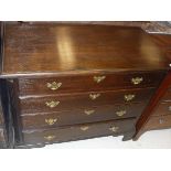 An oak chest of four long graduated drawers flanked by fluted quarter cut side pilasters on bracket