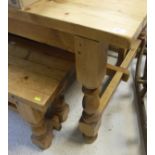 A pine refectory style dining table with plank top on turned and block supports united by a centre