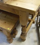 A pine refectory style dining table with plank top on turned and block supports united by a centre