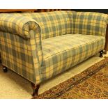 A circa 1900 upholstered two seat sofa in blue and white check,