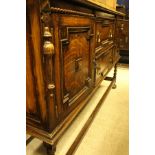 A mid 20th Century oak leaded glazed and linenfold door cabinet,