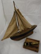 An early to mid 20th Century painted pine pond yacht with weighted keel and cotton sails,