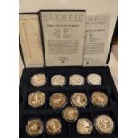 A boxed collection of 37 Olympic commemorative silver coins,