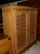 A Continental pine food cupboard with latticework doors in the Louis XV Provincial taste