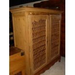 A Continental pine food cupboard with latticework doors in the Louis XV Provincial taste