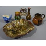 A Linthorpe brown glazed petal shaped bowl, a small Linthorpe conical vase with bamboo decoration,