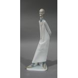 A Lladro figure of 'Doctor' wearing spectacles and stethoscope, long white tunic, triangular base,