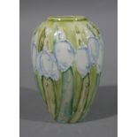 A Lise B Moorcroft small oval vase with tube lined decoration of snowdrops on a green ground