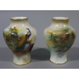 A pair of Royal Worcester small shouldered ovoid vases, one signed A Watkins,