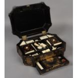 AN EARLY 19TH CENTURY CHINESE EXPORT BLACK LACQUER WORKBOX of panelled rectangular form,