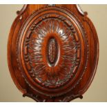 AN EARLY 19TH CENTURY MAHOGANY STICK BAROMETER having an arched top with clover finial,