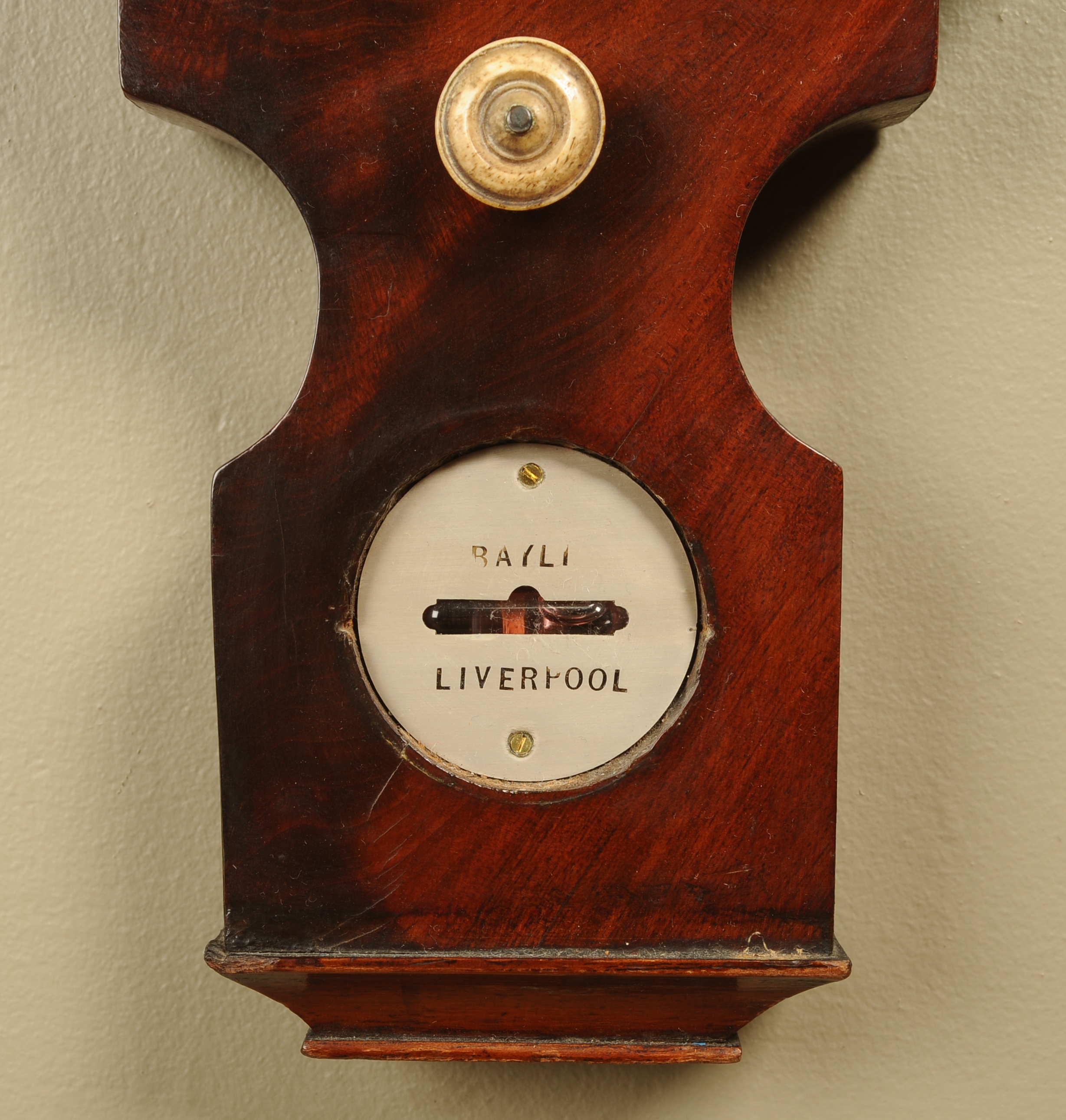 A MAHOGANY BANJO BAROMETER-THERMOMETER by Bayli of Liverpool, having a silvered dial, thermometer,