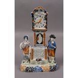 AN EARLY 19TH CENTURY YORKSHIRE PRATTWARE CLOCK GROUP in the form of a money box,