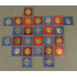 Tin of twenty six modern reproduction coins of British Rulers in plastic cases,